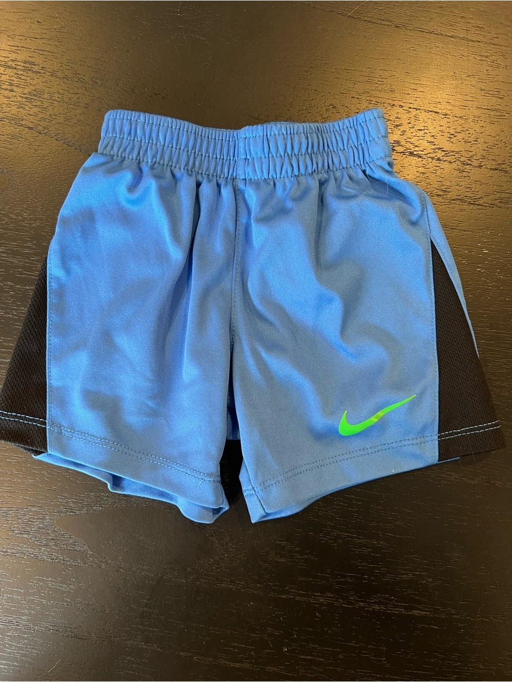 Nike Light Blue Athletic Shorts with Black Panels and Neon Green Swoosh